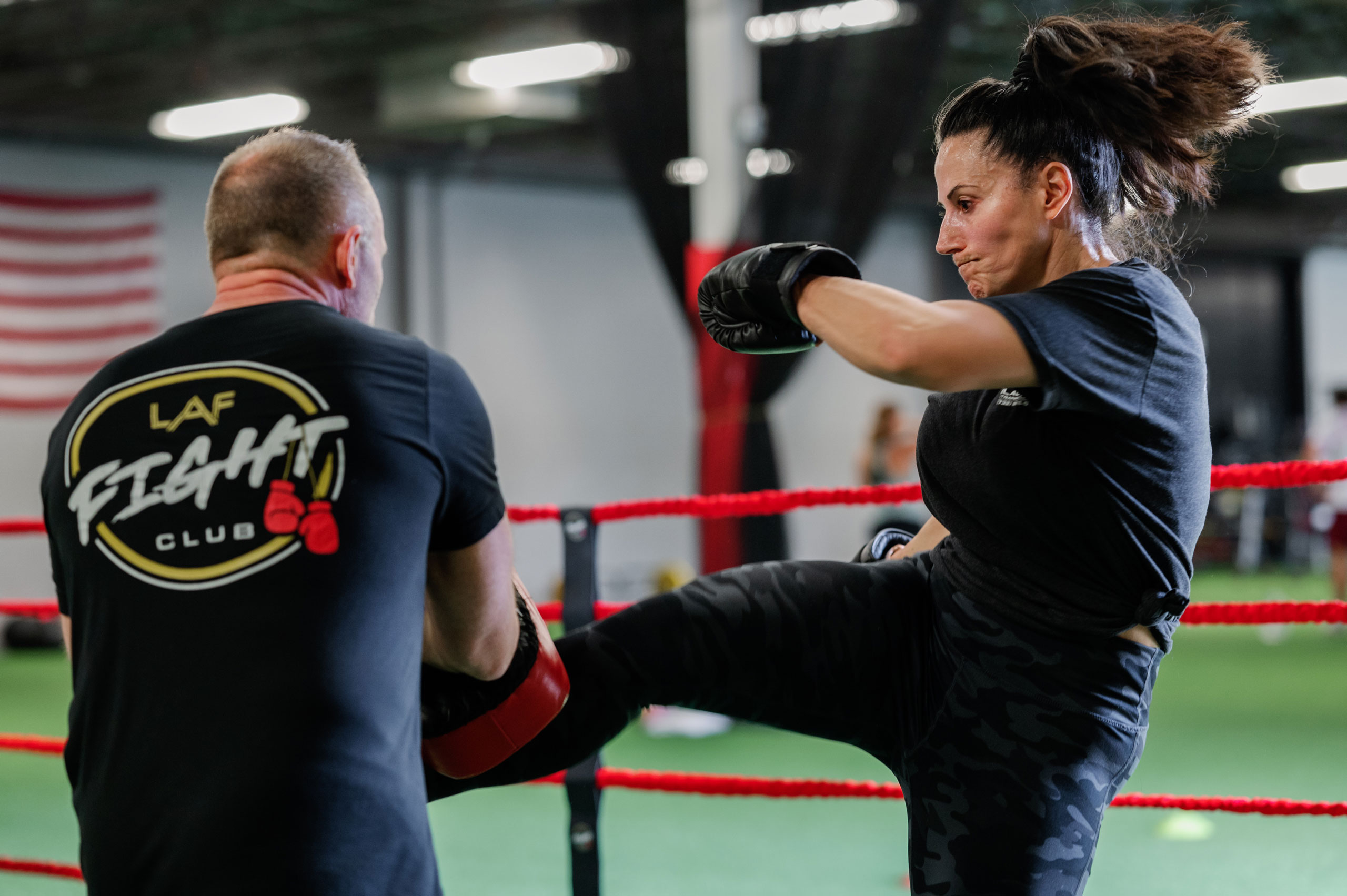 Woman kicking trainer at Fight Club